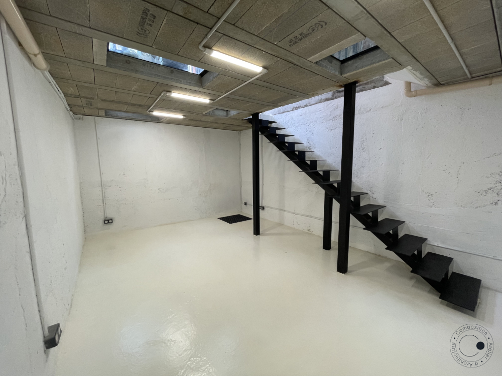 Bouton pour atteindre le descriptif du projet de construction d'un sous-sol d'un appartement • Composition Atelier d'Architecture